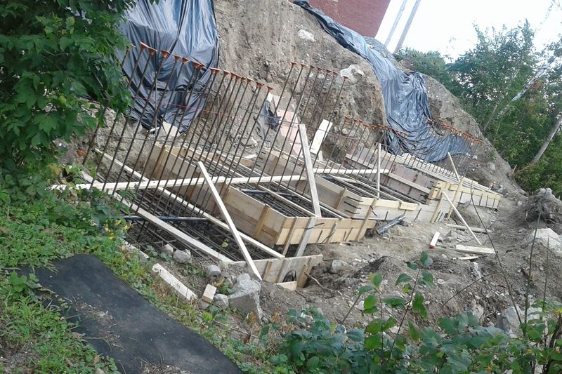 Preparation for concrete pour in foundation up bank from Ammonoosuc River in downtown Littleton, New Hampshire.